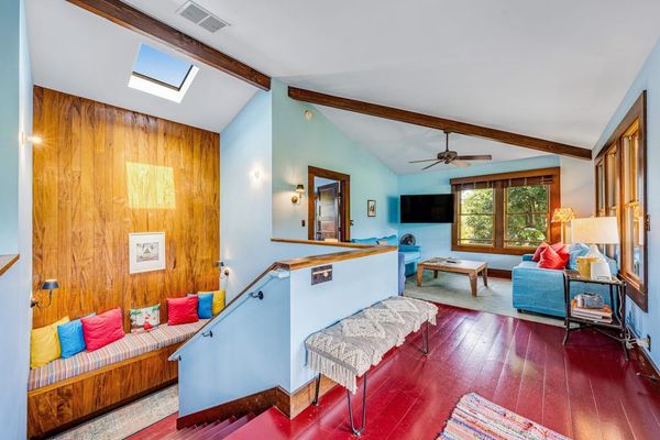 Living room features blue walls, wooden accents, and comfortable seating