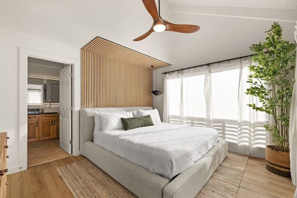 Cozy bedroom with large windows and abundant natural light