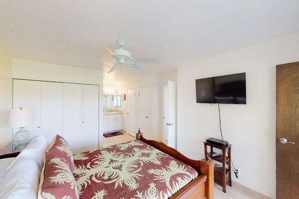 Master bedroom with king bed and a flat screen tv.