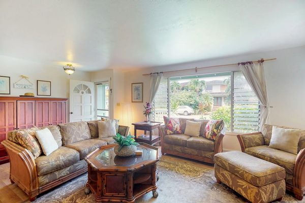Large living room with plenty of comfortable seating for movie nights.