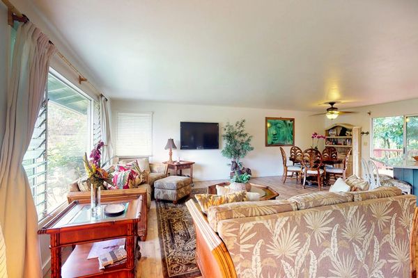 Large living room with plenty of comfortable seating and a flat screen tv for movie nights.