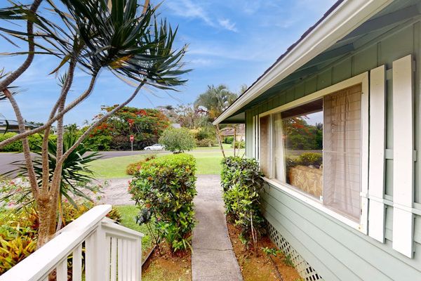 Lush tropical foliage surrounds this lovely home.