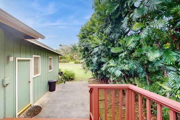 Step outside to the wraparound lanai, where lush tropical foliage creates a peaceful backdrop for morning coffee or evening conversation.