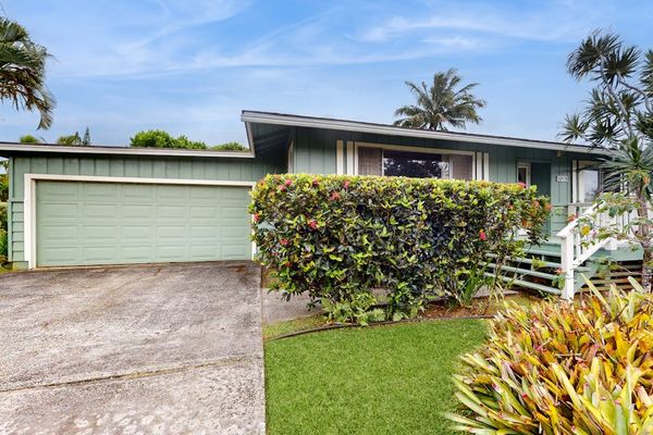 Lush tropical foliage surrounds this lovely home.