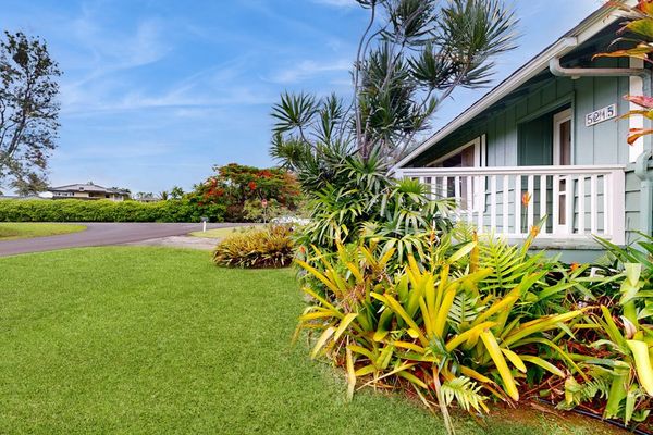 Lush tropical foliage surrounds this lovely home.