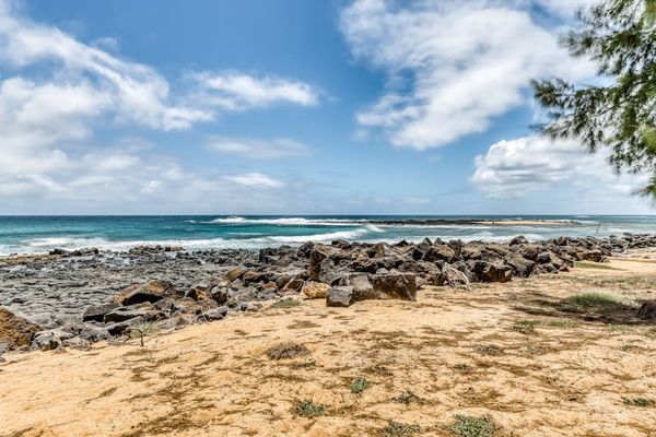 Sandy Beachfront with Rocky Shoreline and Ocean Views