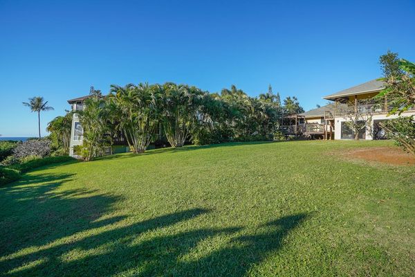 Relax in the spacious tropical backyard filled with fruit trees and blooming orchids. Kids can run and play while you enjoy the peaceful setting and beautiful ocean views from the back of the property.