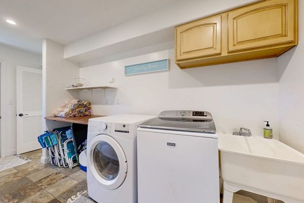 The in-home washer and dryer make family stays easy and convenient along with seven beach chairs, beach towels, water sports gear, and a beach umbrella are available for guest use.
