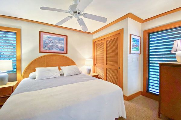 Master bedroom with king bed and flat screen tv.