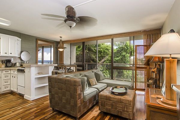 Lovely living room with a flat screen tv and light coming in from the lanai and views of the Pacific Ocean.
