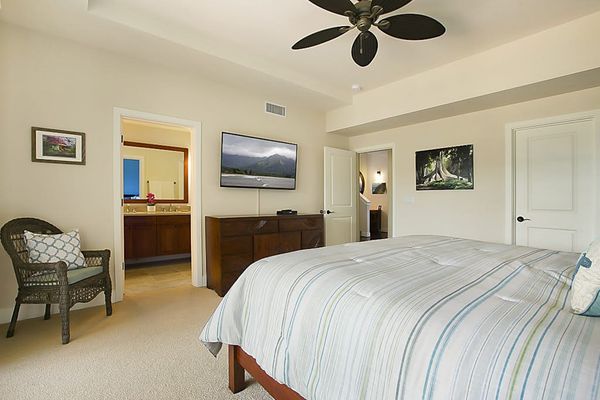 Calming main bedroom with a king bed, private lanai, flat screen tv and en suite bathroom.