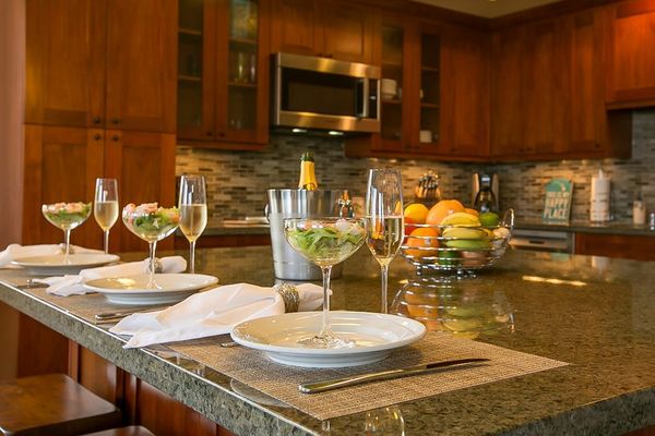 High-end and high-style, the open kitchen boasts handsome cherry cabinets, granite counters, stainless appliances, and a large island with seating for three.