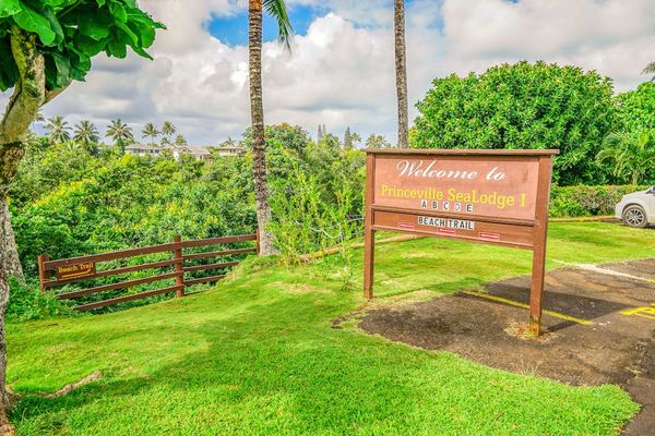 Welcome entrance sign surrounded by lush tropical greenery at Sealodge