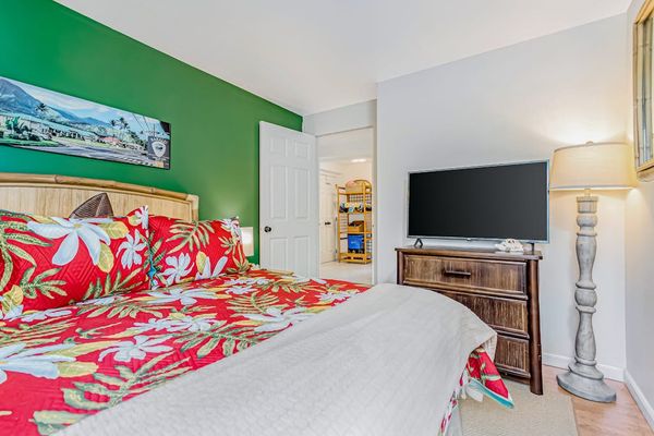 Guest bedroom with queen bed and flat screen tv.