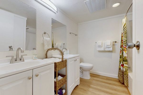 Bright Guest Bathroom Complete With Clean Lines And Plush Towels