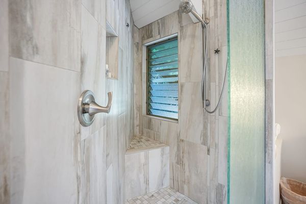 Beautiful walk-in shower with elegant stone tile.