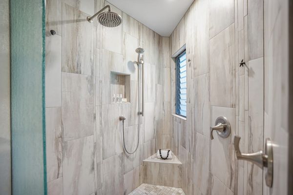 Walk-in shower with beautiful tilework and modern fixtures.