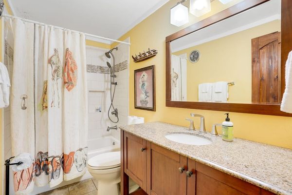 Primary bathroom featuring a clean tub and shower combination.