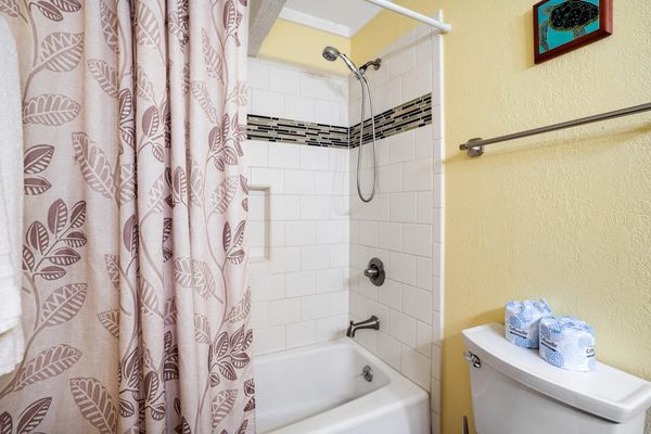 Guest bathroom featuring a clean tub and shower combination.