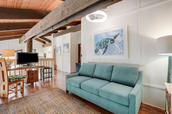Spacious loft area featuring a sofa bed and flat-screen TV, ideal for additional guests to relax.