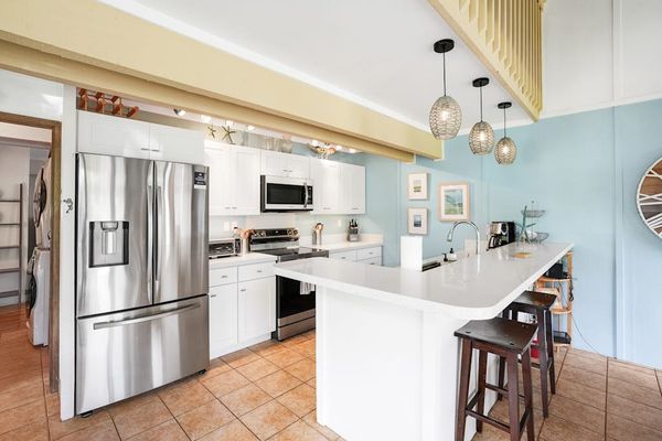 Newly remodeled modern kitchen featuring stainless steel appliances and an island for extra counter space.