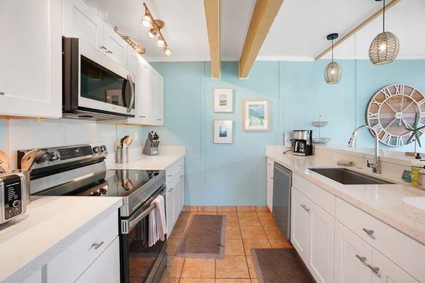 Newly remodeled modern kitchen featuring stainless steel appliances and an island for extra counter space.