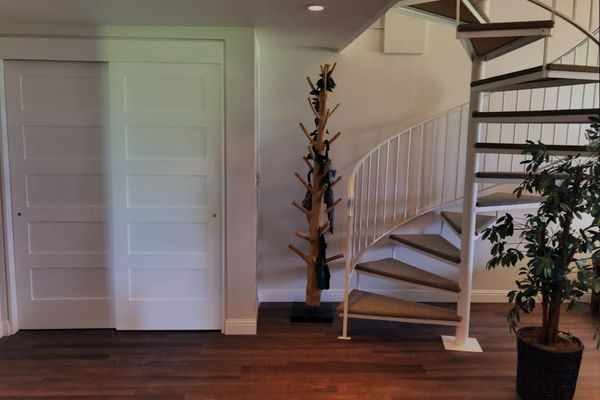 Entryway showcases staircase, decorative plants, convenient interior access, and nearby