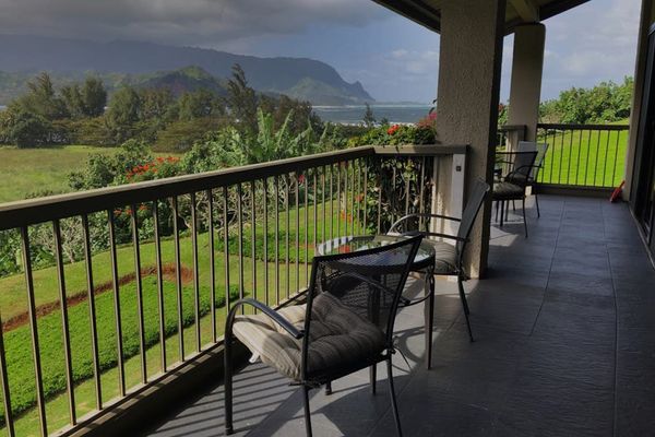 Covered balcony offers seating, garden views, and peaceful outdoor relaxation