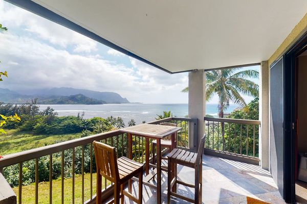 Covered balcony offers dining seating, mountain vistas, and tropical breezes