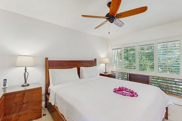 Serene bedroom features layered linens, bedside furnishings, and calming accents