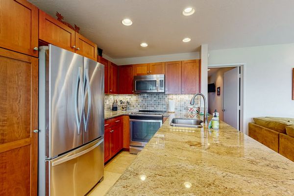 Modern kitchen showcases streamlined cabinetry, useful appliances, and generous counters