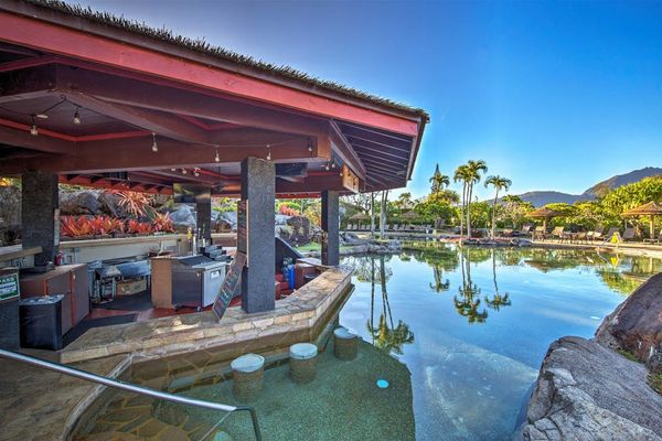 Enjoy relaxing poolside moments from this shaded tropical gathering area