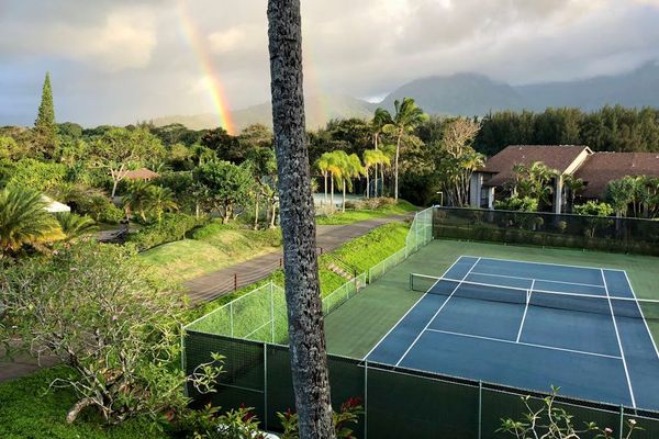 Stay active on tennis courts surrounded by beautiful tropical greenery