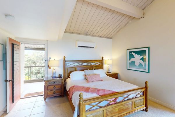 Rest peacefully in this airy bedroom with refreshing outdoor access