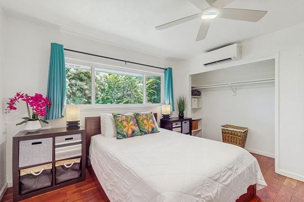 Compact bedroom designed with a breezy, tropical aesthetic