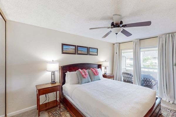 Master bedroom with king bed, flat screen tv and a ceiling fan for comfort.