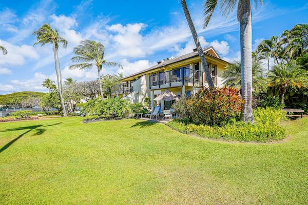 Spacious front yard with beautifully manicured tropical lawns