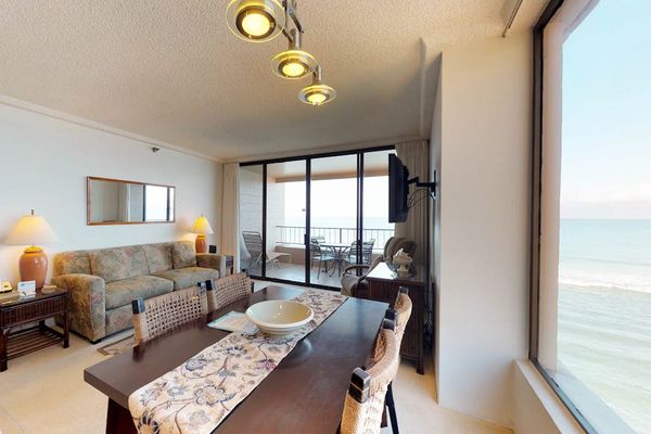 Dining room with seating for five and a view out of the picture window.