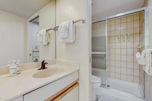 Full bathroom with spacious vanity and tub-shower combination