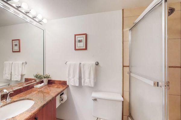Full bathroom with a spacious vanity and tub-shower combination