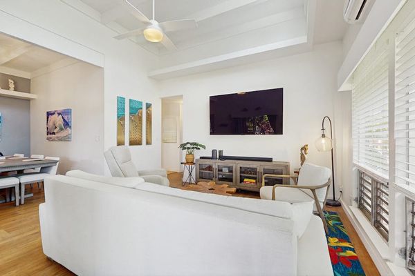 Spacious living room blends cozy seating with elegant details and cheerful daylight.