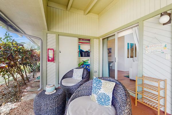 Covered patio offers comfortable seating for outdoor gatherings and dining