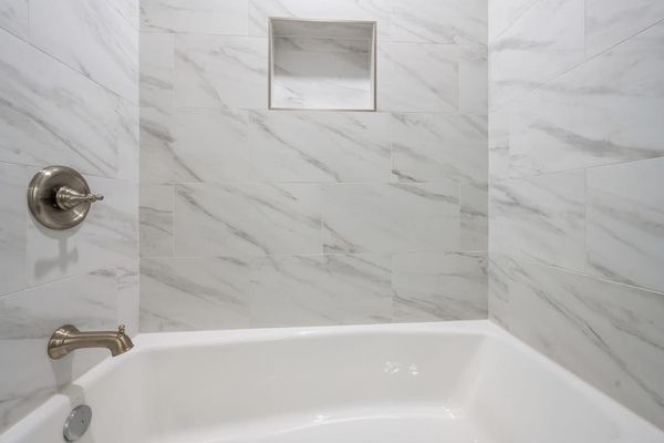 Relax in the clean and inviting tub-shower combination