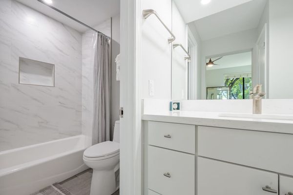 Full bathroom with a bright vanity and tub-shower combination
