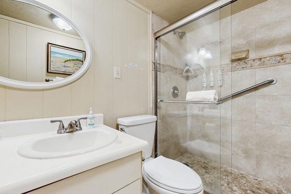 Newly remodeled guest bedroom with walk in tiled shower.