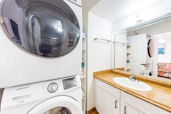 Bright bathroom with generous counter space, convenient drawers, and fresh towels ready for your stay