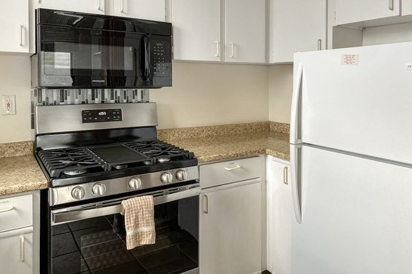 Convenient kitchen appliances, including a refrigerator, stove, and microwave, make meal preparation simple during your stay