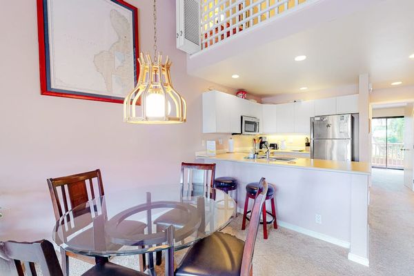 Kitchen dining area showcases modern appliances counters and breakfast seating