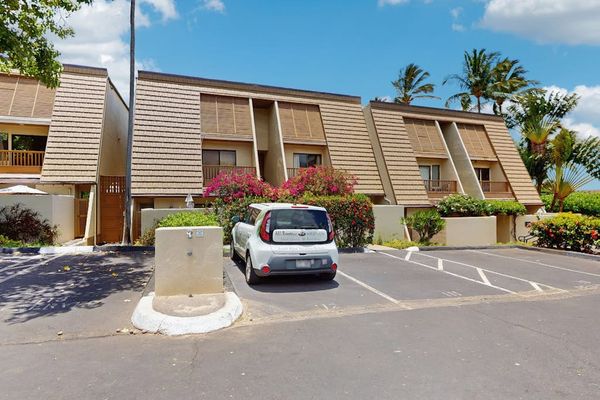 Exterior building entrance offers convenient parking beside landscaped resort grounds