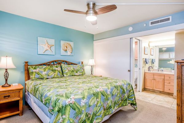 Master bedroom with king bed, ceiling fan, flat screen tv and en-suite bathroom